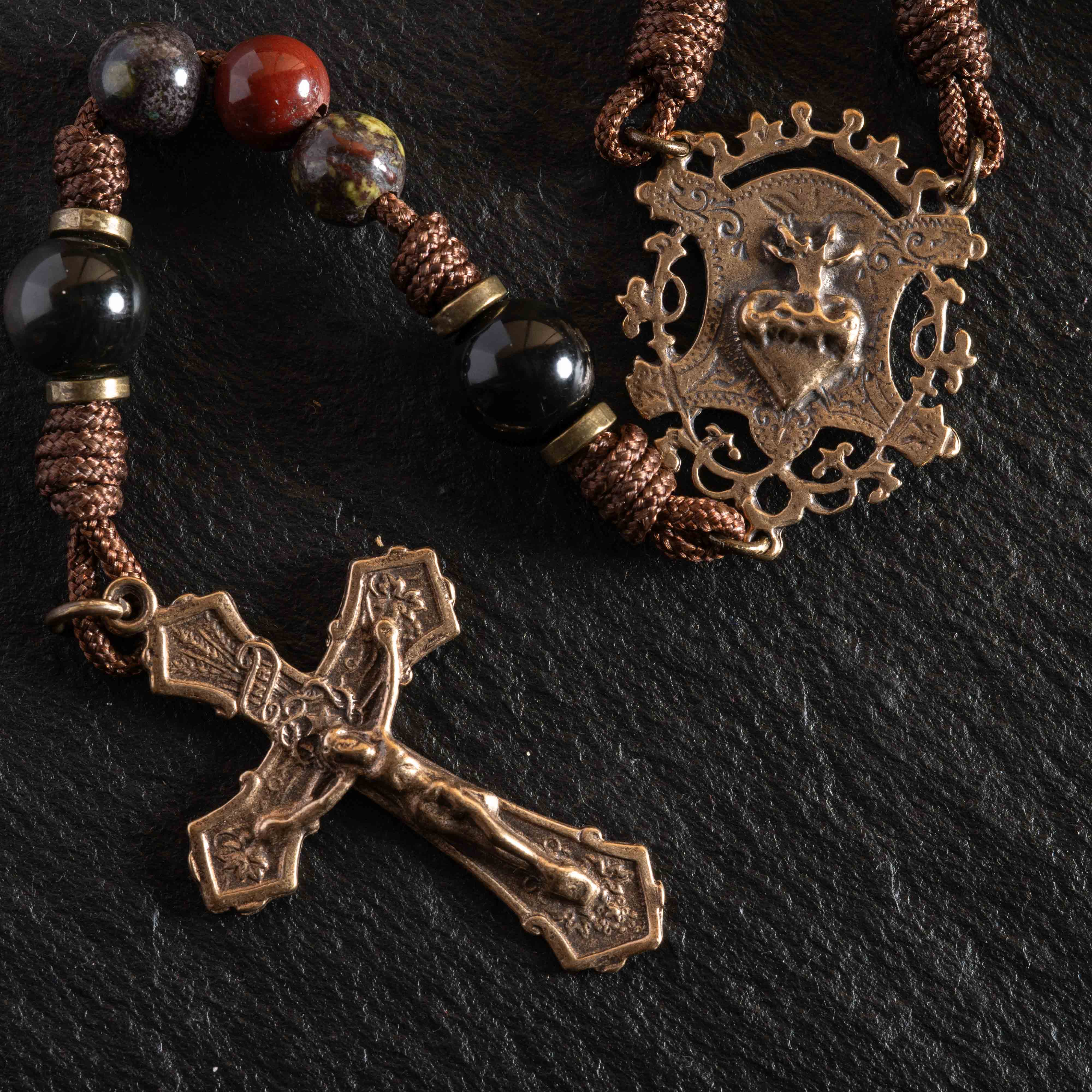 Heirloom Catholic rosary collection with solid bronze crucifixes and natural stone beads on slate