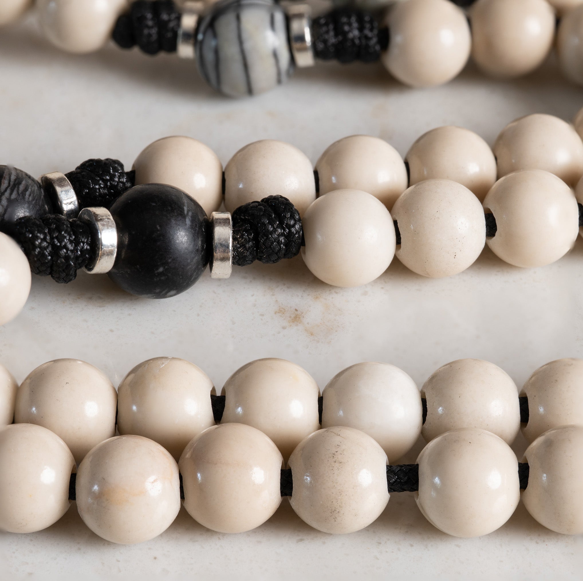 Close-up of Fossil Jasper and Black Picasso Jasper beads on the Our Lady of Sorrows rosary