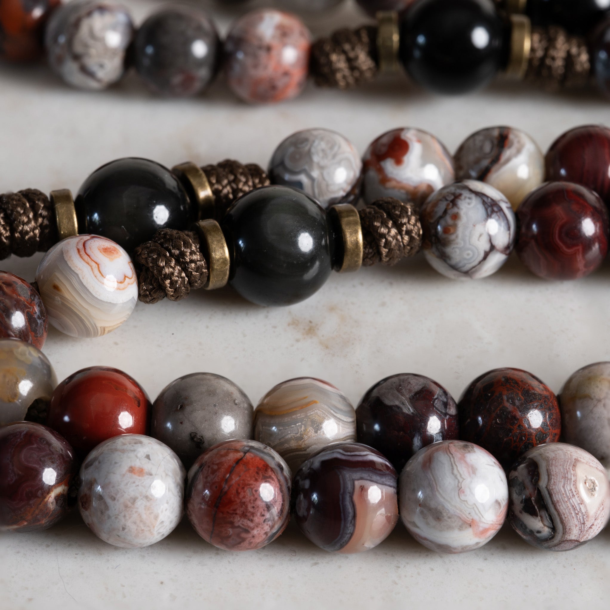 Close-up of Crazy Lace Agate and Rainbow Obsidian beads on the Vessel of Justice rosary